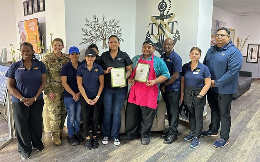 Torpedoes & Tomahawks group photo as Stars and Stripes Pacific Commander Lt. Col. Marci Hoffman presents Best on-base restaurant award to Torpedoes & Tomahawks staff.