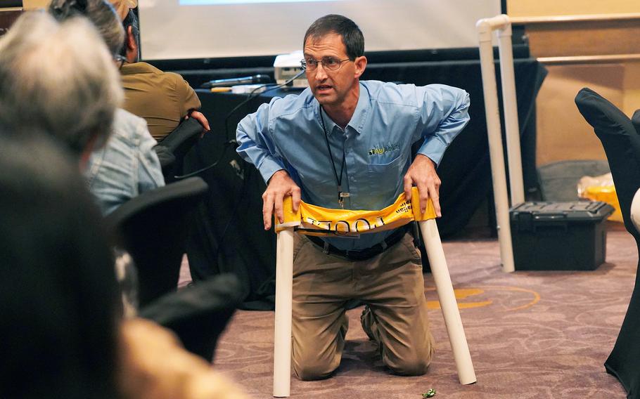 During a breakout session on Oct. 30, 2024, at the Guam AgrAbility Regional Workshop, Ned Stoller, an agricultural engineer and assistive technology professional with the National AgrAbility Project, demonstrates a homemade assistive aid that could be used for harvesting or planting crops.