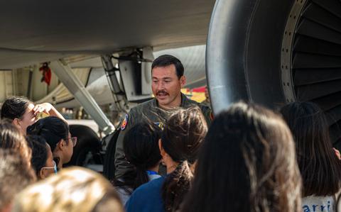 Photo Of 1st Lt. Walker Landry talks to kids about aircraft.