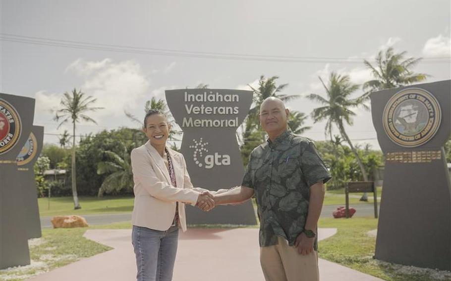 Sharon Davis shakes hands with Inalåhan Mayor Anthony Chargualaf.