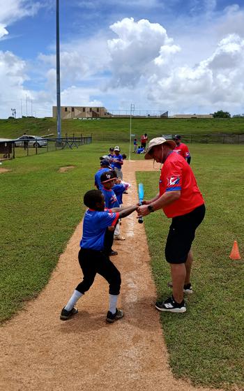 A coach teaching how to swing.