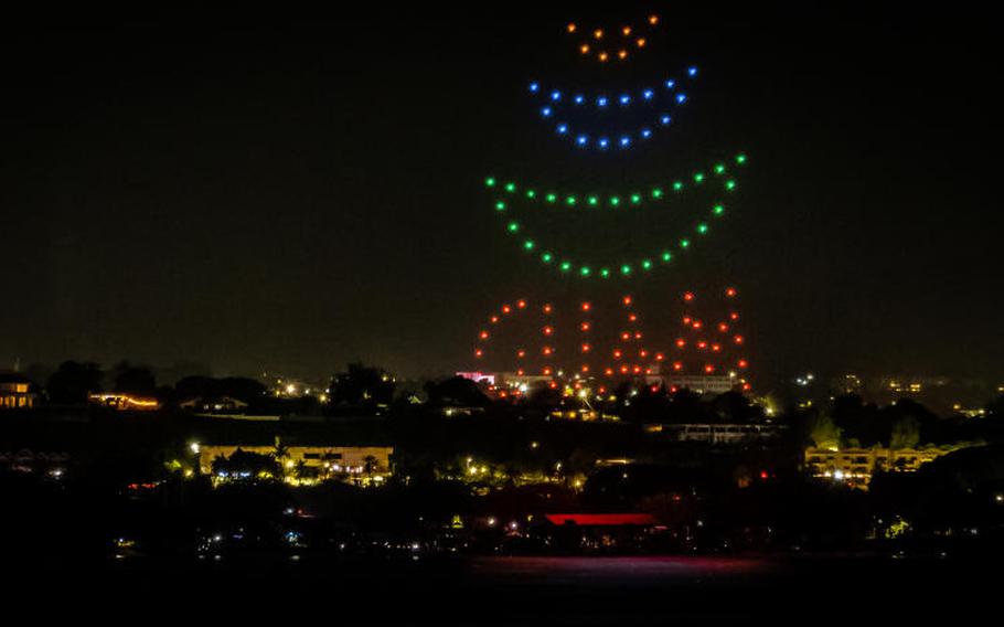 drone show. logo mark of guam visitors bureau and letters which says guam can be seen.