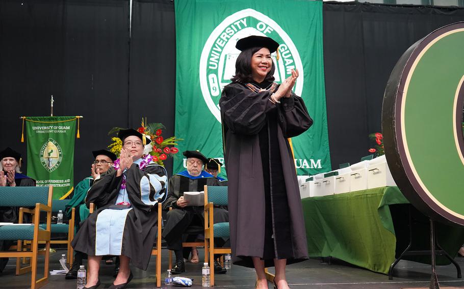 University of Guam President Anita Borja Enriquez applauds the 319 graduates from the commencement stage on May 19 at the Calvo Field House.