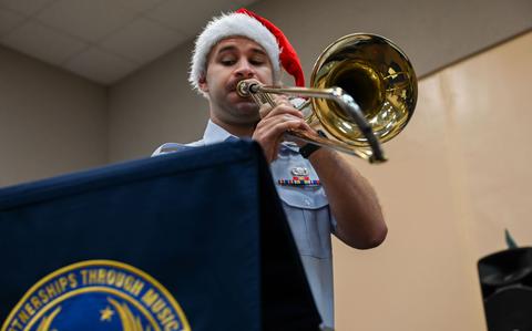 Photo Of U.S. Air Force Senior Airman Jeff Sharoff, regional band trombone for the U.S. Air Force Band of the Pacific-Asia, Pacific Brass Quintet, plays his instrument at Okkodo High School, Dededo, Guam, Dec. 10, 2024.