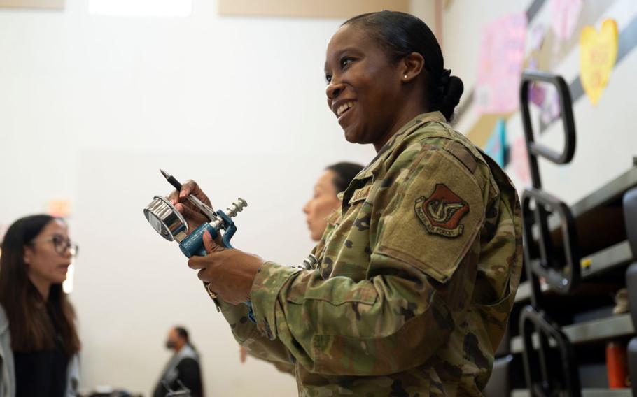 U.S. Air Force Staff Sgt. Ashley Brown, 36th Operational Medical Readiness Squadron physical therapy technician, speaks to students about physical therapy during the Tiyan High School Health Fair in Barrigada, Guam, Feb. 23, 2024. At the fair Airmen from the 36th Civil Engineer Squadron and 36th Medical Group demonstrated carrying a patient, applying a tourniquet, and walked students through various physical therapy exercises.