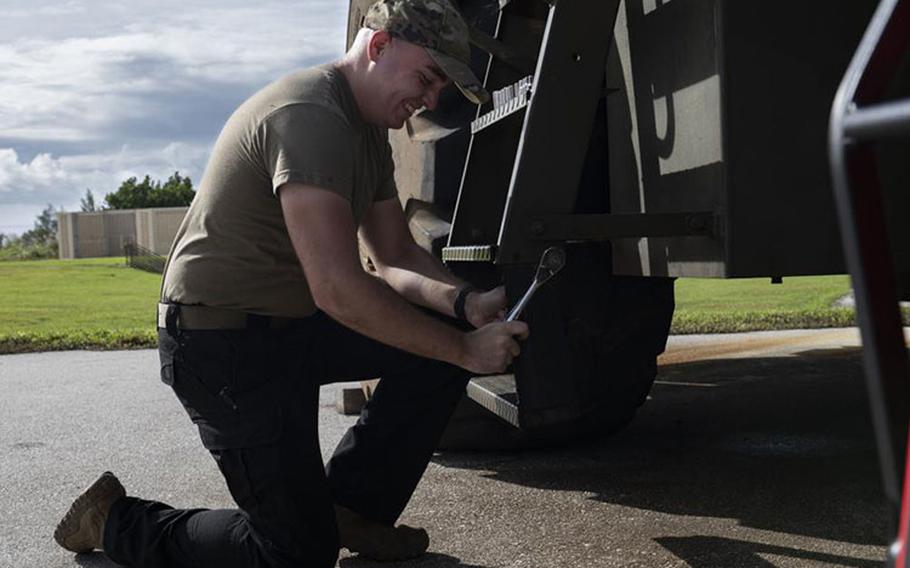 U.S. Air Force Senior Airman Branden Formby, 36th Logistics Readiness Squadron Vehicle Management Flight vehicle maintainer, detaches stairs off of a vehicle on Andersen Air Force Base, Guam, Oct. 13, 2022. The Vehicle Management Flight is a new addition to the 36 LRS which was previously manned by Invicta Defense contractors. (U.S. Air Force photo by Airman 1st Class Lauren Clevenger)