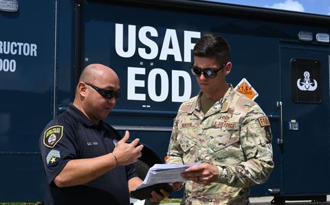 Photo Of Guam Police’s Officer POIII Glenn C. Ogo explains documents with U.S. Air Force Staff Sgt. Austin Denton 36th Civil Engineering Squadron explosive ordinance apprentice during a training exercise in Guam, Nov. 29, 2024.