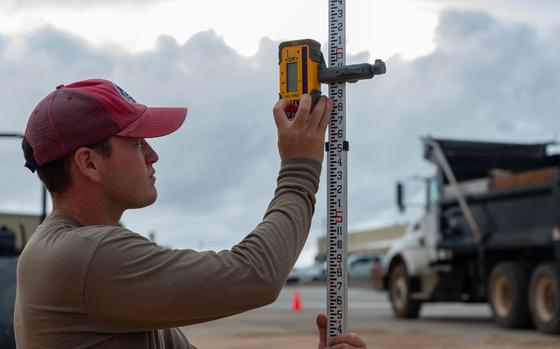 Photo Of U.S. Air Force Senior Airman Ryan Werder, 554th Rapid Engineer Deployable Heavy Operational Repair Squadron Engineers engineering technician, calibrates an electronic leveler for a K-SPAN foundation at Andersen Air Force Base, Guam, Aug. 29, 2024.