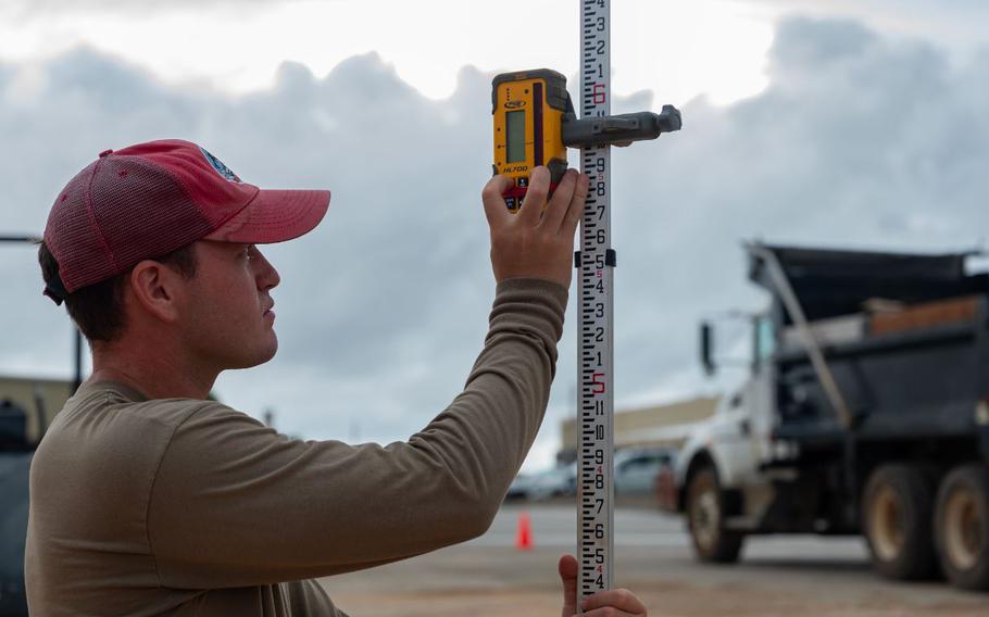 U.S. Air Force Senior Airman Ryan Werder, 554th Rapid Engineer Deployable Heavy Operational Repair Squadron Engineers engineering technician, calibrates an electronic leveler for a K-SPAN foundation at Andersen Air Force Base, Guam, Aug. 29, 2024.