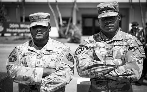 Photo Of U.S. Air Force Master Sgt. Mark Harshaw, 36th Force Support Squadron resource advisor section chief, and Tech. Sgt. Freddie Foust, 36th Civil Engineering Squadron fire and emergency services section chief, pose for a photo in front of the 36th Wing Headquarters building at Andersen Air Force Base.