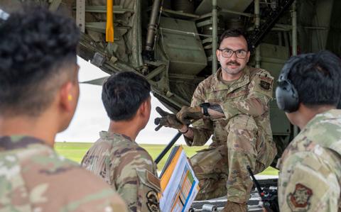 Photo Of Staff Sgt. James Stiegler, 41st Airlift Squadron instructor loadmaster from Little Rock Air Force Base, Arkansas, briefs Airmen following the arrival of a C-130J Super Hercules at Andersen Air Force Base, Guam.
