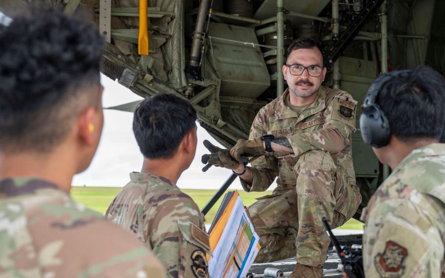 Staff Sgt. James Stiegler, 41st Airlift Squadron instructor loadmaster from Little Rock Air Force Base, Arkansas, briefs Airmen following the arrival of a C-130J Super Hercules at Andersen Air Force Base.