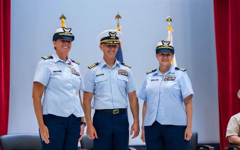 Cmdr. Abigail Clark (right) assumes command of U.S. Coast Guard Base Guam from Cmdr. Dana Hiatt (left) in a change of command ceremony at the Naval Base Guam Theater in Santa Rita.
