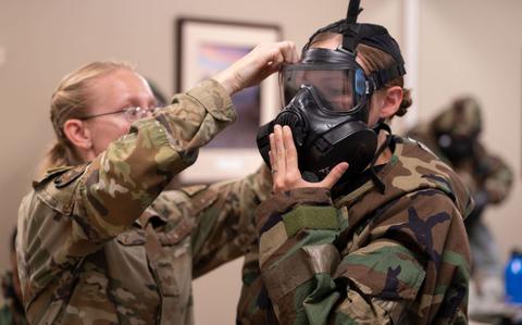 Photo Of U.S. Air Force Tech. Sgt. Eva Raetz, 36th Civil Engineering Squadron Emergency Management Section Chief, helps U.S. Marine Hannah Deems, Camp Blaz Administrative Specialist, adjust her hazardous material gear during a multiple branch Chemical, Biological, Radiological, and Nuclear (CBRN) training at Andersen Air Force Base, Guam, Mar. 27, 2024.