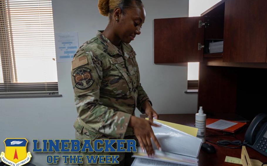 U.S. Air Force Airman 1st Class Nevaeh Guisao, a 644th Combat Communications Squadron communications security technician, reads through a COMSEC binder at Andersen Air Force Base, Guam, Oct. 4, 2023. The Team Andersen Linebacker of the Week recognizes outstanding enlisted, officer, civilian and total force personnel who have had an impact on achieving Team Andersen’s mission, vision and priorities. (U.S. Air Force photo illustration by Senior Airman Jasmine M. Barnes)