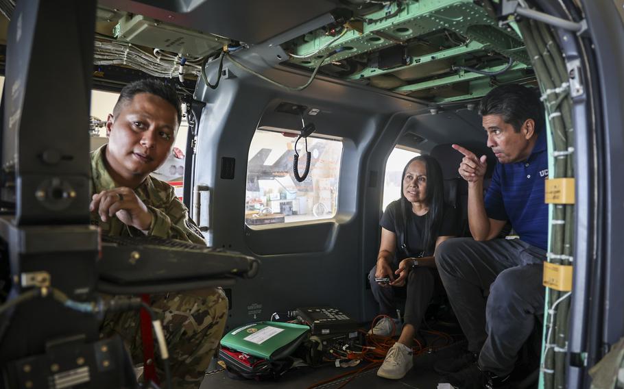 Palau President Surangel S. Whipps, Jr., right, and First Lady Valerie R. Whipps identify a landmark one mile away, shown by U.S. Army Chief Warrant Officer 3 Brian Enderes using optics in a Guam National Guard UH-70 Lakota helicopter, Guam.