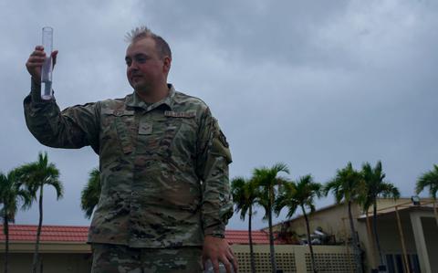 Photo Of U.S. Air Force Airman 1st Class Nicholas Clark, 36th Operations Support Squadron weather apprentice and forecaster, inspects a rain gauge to measure precipitation during exercise Resolute Force Pacific 2025.