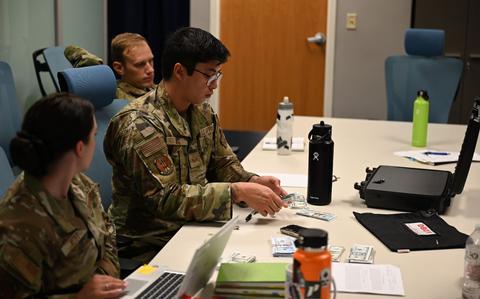 Photo Of Senior Airman Jason King, 36th Comptroller Squadron financial analyst, handles money as part of Slingstone 24-4.