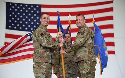 Photo Of U.S. Air Force Col. Charles Cooley, the 36th Wing commander, passes the guidon to Col. Shaun Parker, incoming commander of the 36th Mission Support Group, at Andersen Air Force Base, Guam.