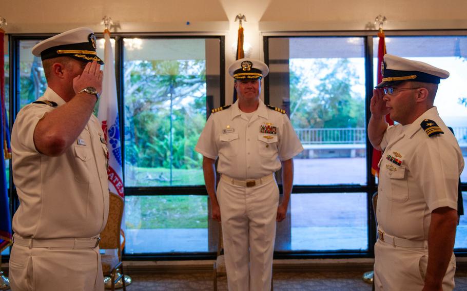 U.S. Navy Cmdr. Anthony Culwell, officer in charge of Naval Information Warfare Center (NIWC) Activity Facility Pacific Guam, left, relinquished charge to incoming Lt. Cmdr. Ryan Maas, right, in front of NIWC Pacific Commanding Officer Capt. Patrick McKenna during a change of charge ceremony, July 12, 2024, at Top O’ the Mar on Nimitz Hill, Guam.