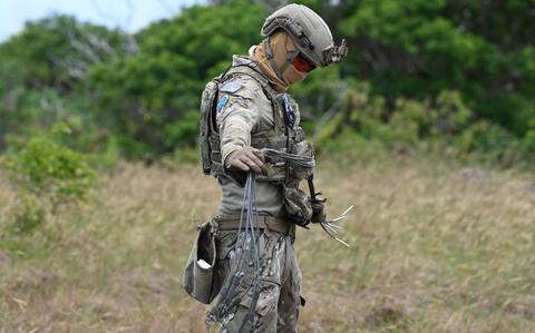 Photo Of U.S. Air Force Airman 1st Class Rafael Torres, 36th Civil Engineering Squadron, explosive ordnance disposal (EOD) team member, straightens gear during EPIC CRAB 25 Exercise at Northwest Field, Andersen Air Force Base.