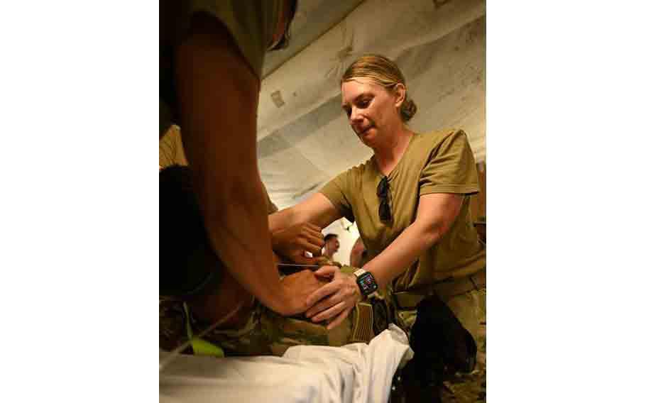 U.S. Air Force Master Sgt. Alyce Park, respiratory therapist for the 673rd Healthcare Operations Squadron, restrains a simulated stress inoculation medical patient during exercise Resolute Force Pacific 2025.
