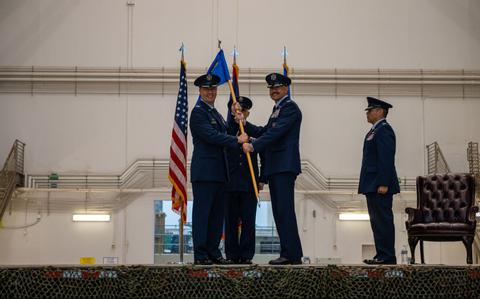 Photo Of U.S. Air Force Col. Dan Cooley, commander of the 36th Wing, hands the guidon to Col. Andrew Miller, incoming commander of the 36th Contingency Response Group, during a change of command ceremony