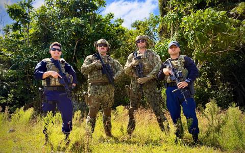 Photo Of The U.S. Coast Guard team, comprised of members from the Forces Micronesia Sector Guam Sector Boarding Team and Port Security Unit 311, stands for a photo prior to the Battle of the Branches joint competitive marksmanship challenge at Andersen Air Force Base on Nov. 22, 2024.