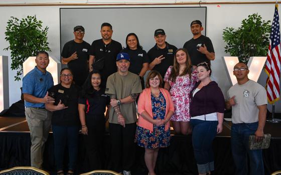 36th Force Support Squadron members pose for a photo with American comedian and actor, Jo Koy, at the Sunrise Conference Center on Andersen Air Force Base.