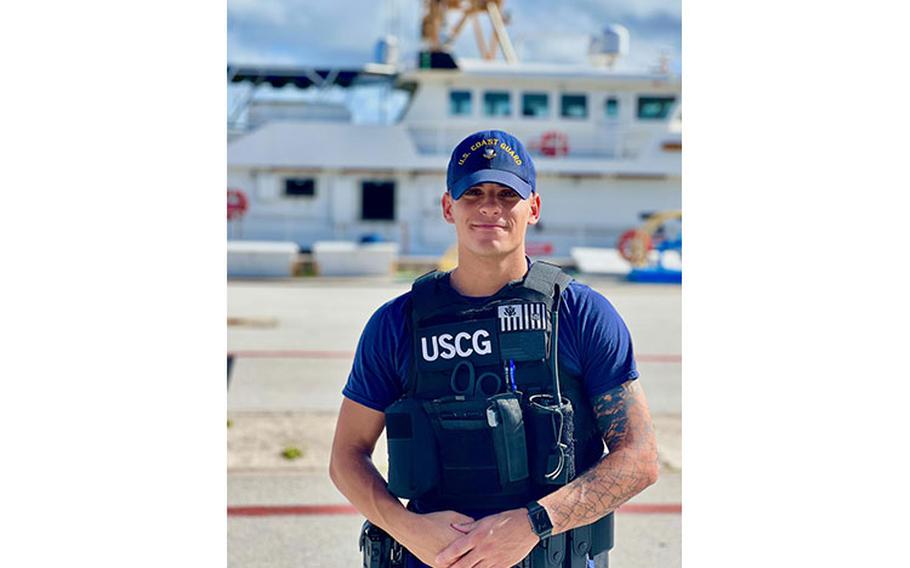 Petty Officer 2nd Class Andrew Lombardi stands for a photo while working gate security during a community youth visit to U.S. Coast Guard Forces Micronesia/Sector Guam on Dec. 9, 2022. Lombardi is part of the unit's Sector Boarding Team. (U.S. Coast Guard photo by Chief Waraant Officer Sara Muir)