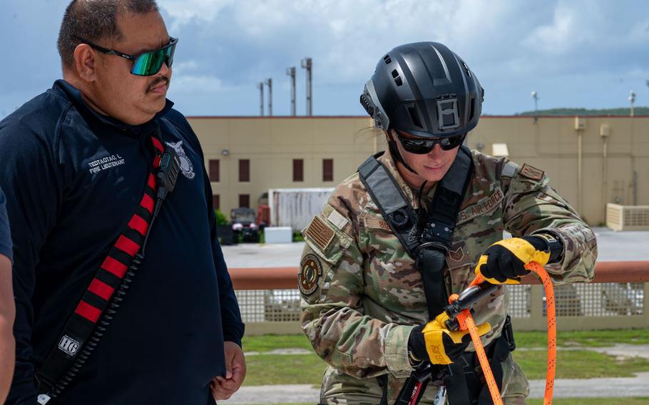 U.S. Air Force Tech. Sgt. Brittany Souder, right, 36th Tactical Advisory Squadron independent duty medical technician, prepares to rappel during rescue technician training at Andersen Air Force Base, Guam, July 16, 2024.