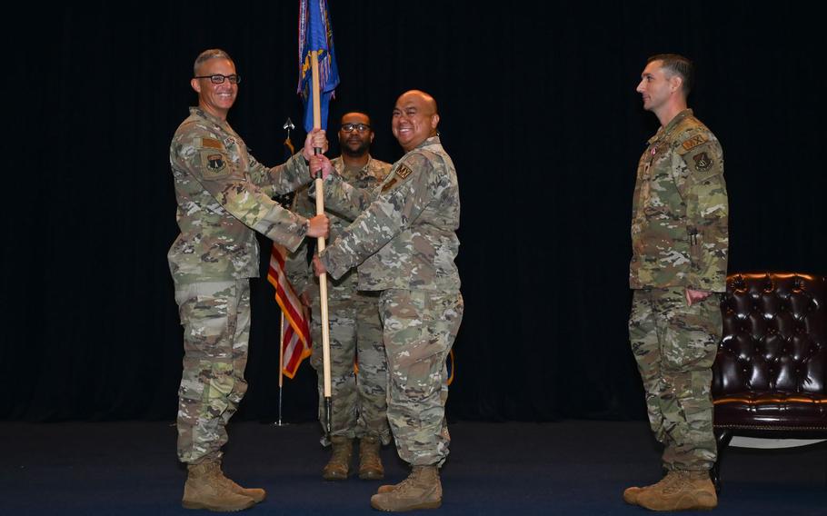 U.S. Air Force Col. James Hendrickson, 36th Maintenance Group commander, passes the 36th Maintenance Squadron guidon to Maj. Christopher Smith, present 36th MXS commander, during the 36th MXS change of command ceremony at Andersen Air Force Base, Guam.