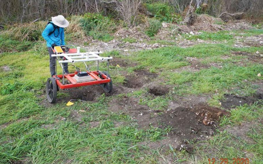 An unexploded ordnance technician collects readings during an intrusive investigation of digital geophysical mapping target anomalies near Chiget Beach in Tinian Dec. 29, 2020. Naval Facilities Engineering Systems Command (NAVFAC) Pacific and NAVFAC Marianas are working with the local government to restore public access to the beach, which is part of the former Tinian Mortar Range. (Courtesy photo)
