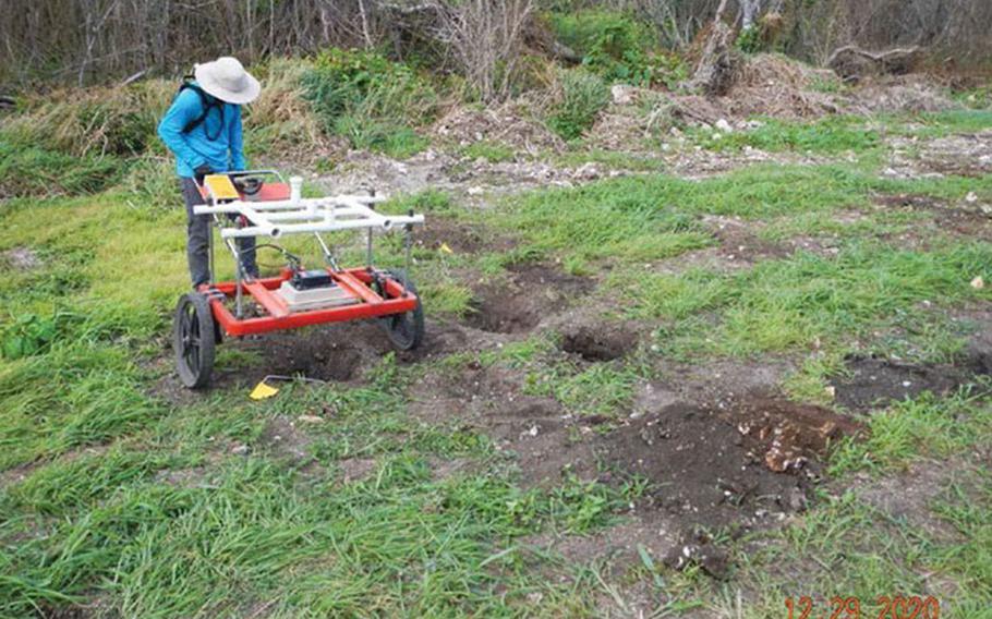 An unexploded ordnance technician collects readings during an intrusive investigation of digital geophysical mapping target anomalies near Chiget Beach in Tinian Dec. 29, 2020. Naval Facilities Engineering Systems Command (NAVFAC) Pacific and NAVFAC Marianas are working with the local government to restore public access to the beach, which is part of the former Tinian Mortar Range. (Courtesy photo)