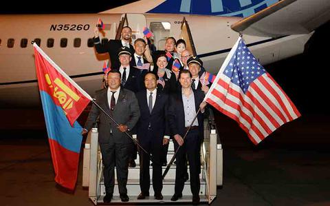 Photo Of United Airlines’ staff posing for a photo in front of an airplane to celebrate the UA’s first ever flight from Tokyo/Narita to Ulaanbaatar, Mongolia