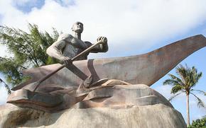 A statue of a man paddling a boat.