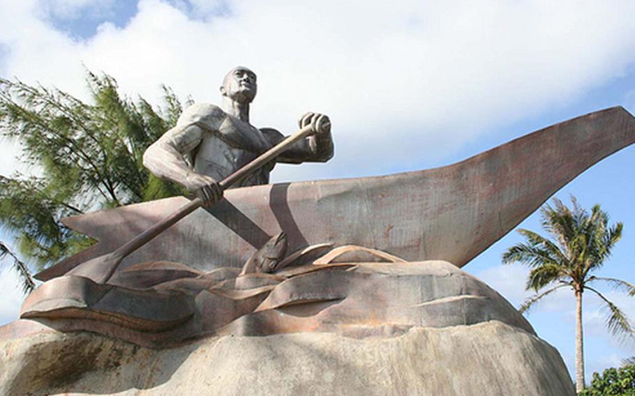 A statue of a man paddling a boat.