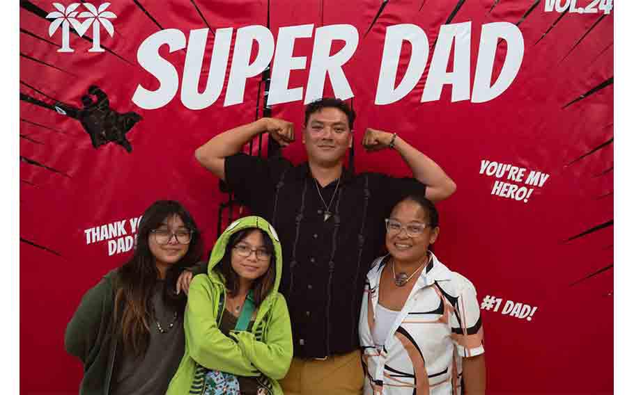 A family takes a photo during Micronesia Mall’s Father’s Day event in 2024.