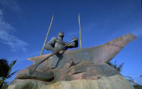 a statue of a man rowing.